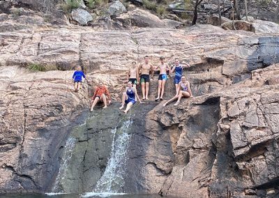 Group on top of waterfall