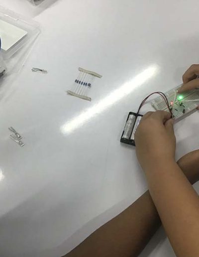 Students wiring up a circuit with LED