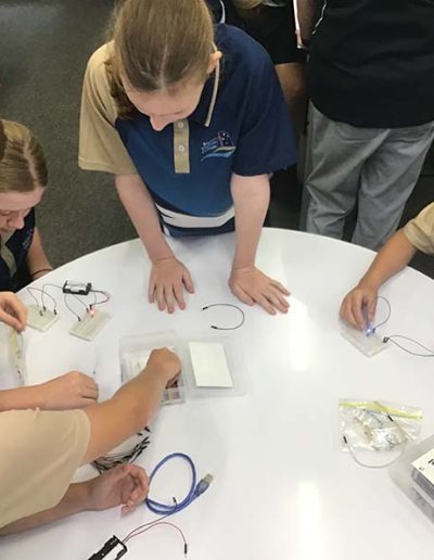 Students wiring up a circuit with LED