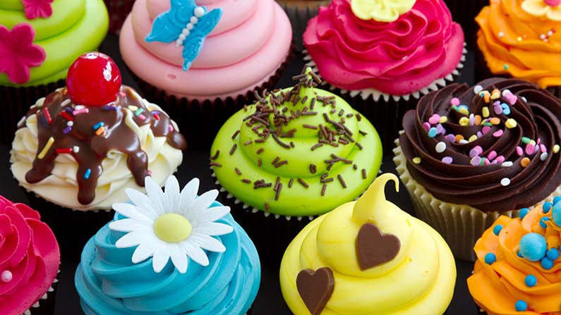 Assortment of brightly decorated cupcakes